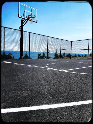 an empty basketball court with a basketball hoop at The Iona Heights Inn in Iona