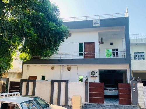 a house with a car parked in front of it at Star light in Islamabad