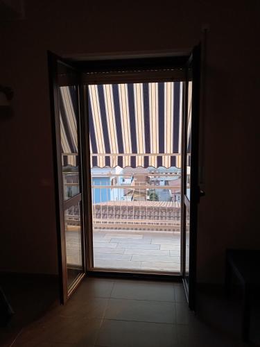an open glass door with a view of a building at Le Zagare b&b in Paola