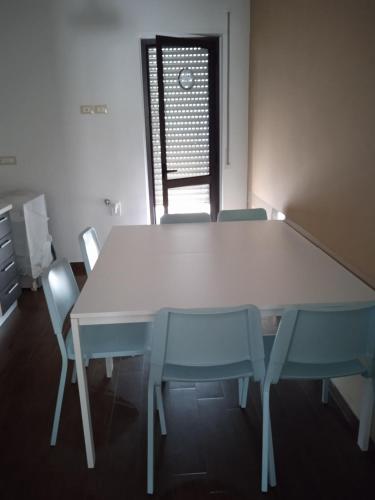 a white table and chairs in a room with a window at Le Zagare b&b in Paola