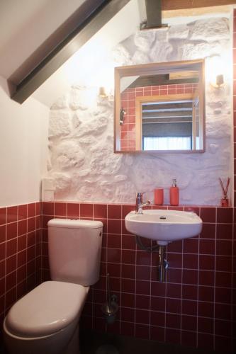 a bathroom with a toilet and a sink at Casa da Praça Velha Guest House in Braga