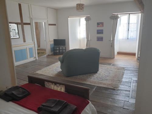 a bedroom with a couch and a chair and a bed at Le Chateau in Châteauponsac