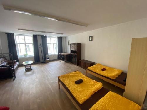 a living room with two beds and a couch at Old Town Apartments R11 in Olomouc