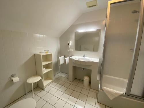 La petite salle de bains est pourvue d'un lavabo et d'une douche. dans l'établissement Hotel Spitze Warte, à Rüthen