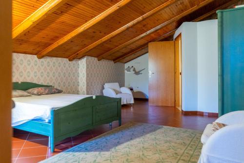 a bedroom with two beds and a wooden ceiling at casa n'donda in Cuccaro Vetere