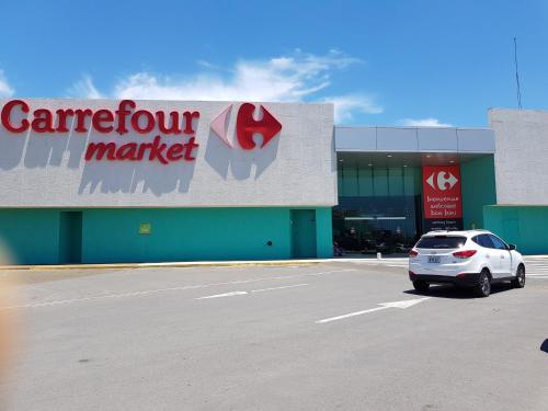 a car parked in a parking lot in front of a market at Fabulous Ocean View Apartment in Secure Resort, 5 min Walk to Beaches & Restaurants in Willemstad