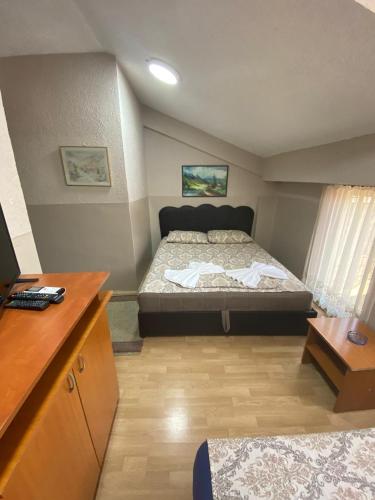 a bedroom with a large bed in a room at Hotel Santos in Skopje