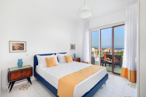 a bedroom with a bed with a view of the ocean at Estate4Home - Casa Maridea in Sorrento