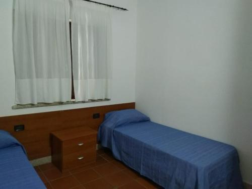 Letto o letti in una camera di Villa Raffaello
