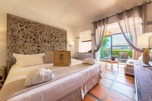 a bedroom with a large bed with a box on it at Hôtel Le Roi Théodore & Spa in Porto-Vecchio