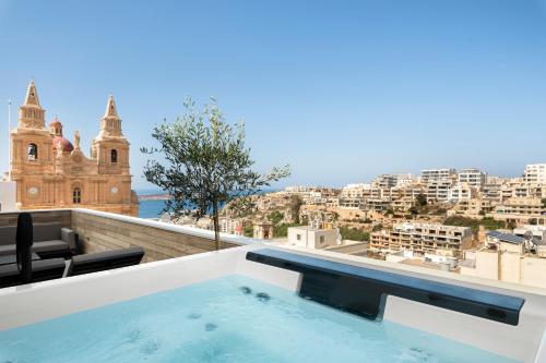 a swimming pool on the roof of a building at Lure Hotel & Spa - Adults Only in Mellieħa
