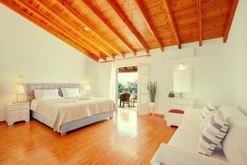a bedroom with a bed and a couch at Villa Angelo in Kassiopi