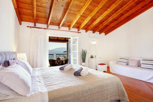 a bedroom with a large bed with towels on it at Villa Angelo in Kassiopi
