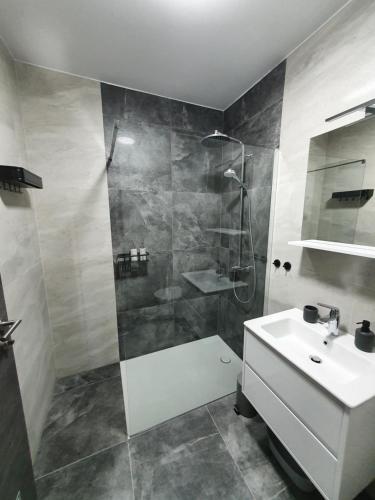 a bathroom with a shower and a sink at Apartmani Nerium in Lovište