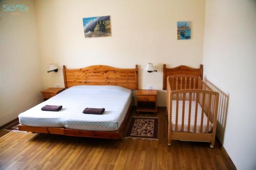 a small bedroom with a bed and a crib at Sensi Hotel in Marsaskala