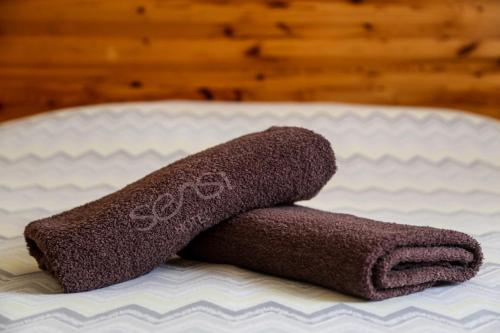 a towel sitting on top of a bed at Sensi Hotel in Marsaskala