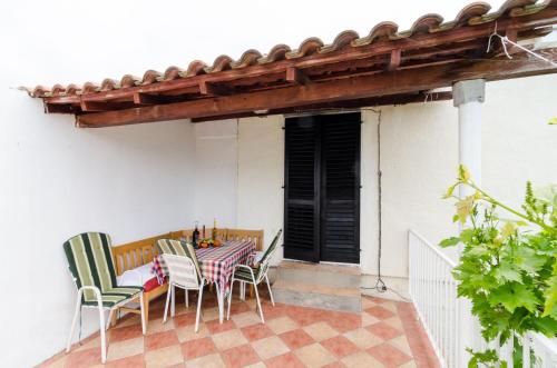a table and chairs sitting on a patio at Guest House Kola in Slano