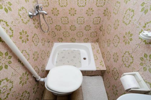 a bathroom with a toilet and a sink at Guest House Kola in Slano