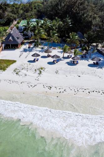 an aerial view of a beach with umbrellas and the water at Amani Boutique Hotel - Small Luxury Hotels of the World in Paje