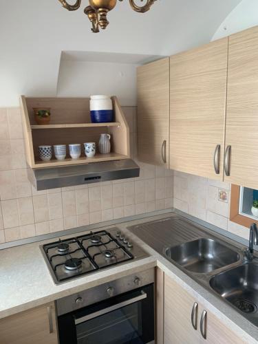 a kitchen with a stove and a sink at Casa Ilaria - Appartamento in Piazzetta in Capri