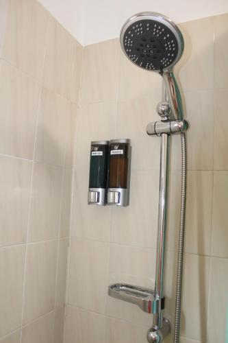 a shower with a shower head in a bathroom at ApartamentosPlaya_Hermigua in Hermigua