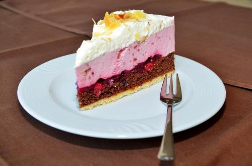 a piece of cake on a plate with a fork at velcrea in Willebadessen