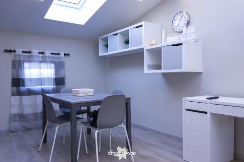 a dining room with a table and chairs and a clock at Casa di Irene in Reggio Emilia