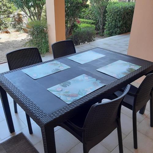 a black table with four chairs around it at Luna e Mare in Cala Gonone