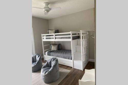a bedroom with a white bunk bed in a room at Beach Jewel 5bd-3 1/2 bath -5 min walk to Beach! in Destin