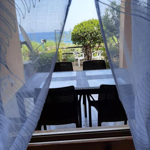 a table and chairs with a view of the ocean at Luna e Mare in Cala Gonone