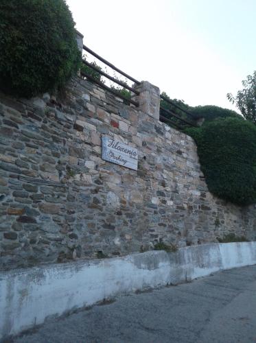 a brick wall with a sign on it at Filoxenia- Drakia in Drakeia
