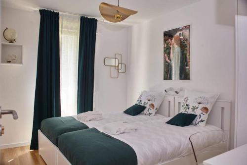 - une chambre avec un grand lit blanc et des rideaux bleus dans l'établissement La vallée des Hortillonages, à Amiens