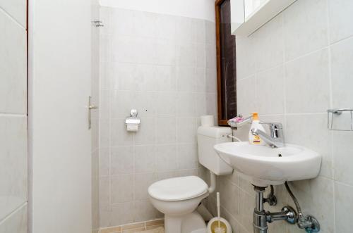 a bathroom with a toilet and a sink at Guest House Kola in Slano