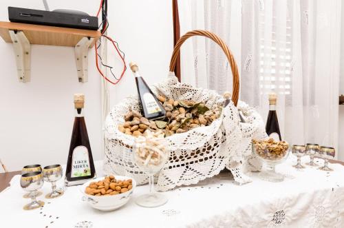 a basket of food and bottles of wine on a table at Guest House Kola in Slano