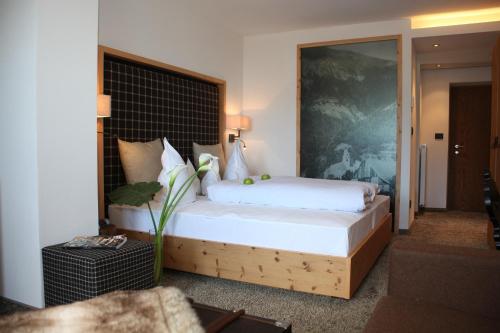 a bedroom with a large bed in a room at Hotel Patriarch in Tirolo