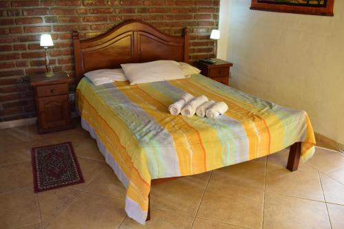 a bedroom with a bed with two towels on it at Estancia Santa Leocadia in Bialet Massé