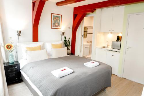 a bedroom with a bed with two towels on it at Sunflower Amsterdam in Amsterdam