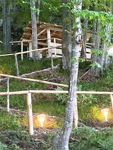 two lights in the grass next to a log cabin at LA RĂSCRUCE DE APE in Suceviţa