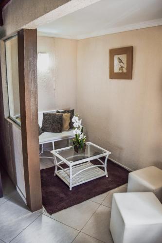 a living room with a couch and a table at Pousada Recanto do Lobo in Porto De Galinhas