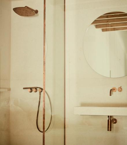 a shower in a bathroom with a mirror at AF Lindia Nature Design Hotel in Líndos