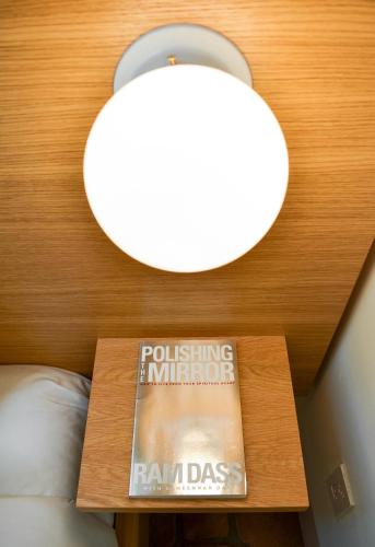 a book on a table in a room with a lamp at The Parador in Santa Fe