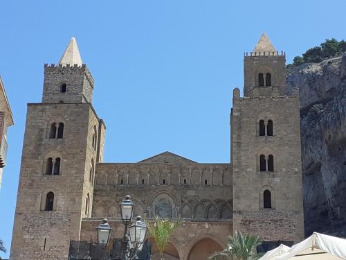 a large stone church with two towers at Calypso in Cefalù