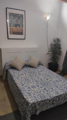 a bedroom with a bed with pillows on it at Valldemosa Sleep & Hike in Valldemossa