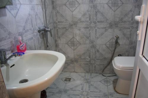 a bathroom with a sink and a toilet at White Room in Gabala