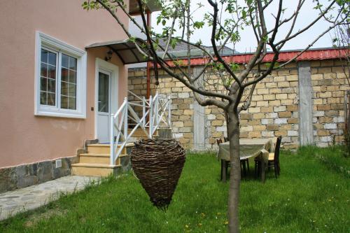 a table and chairs in front of a house at White Room in Gabala