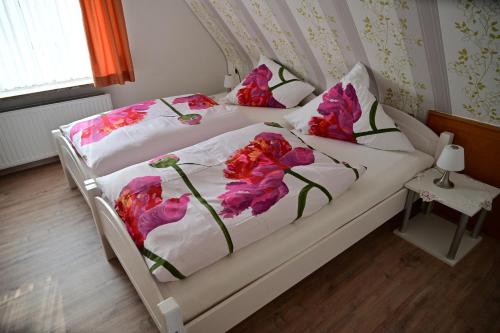 a bedroom with a bed with pink flowers on it at Haus Lisa Burg Dithmarschen am Nord Ostsee Kanal Nordsee in Burgerfeld