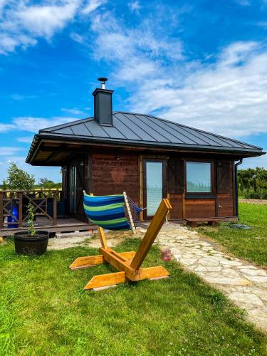 a house with a blue chair in front of it at Luksusowe całoroczne domki z widokiem Janowiec in Janowiec
