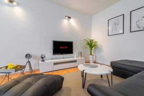 a living room with a couch and a tv at Olive gardens in Primošten