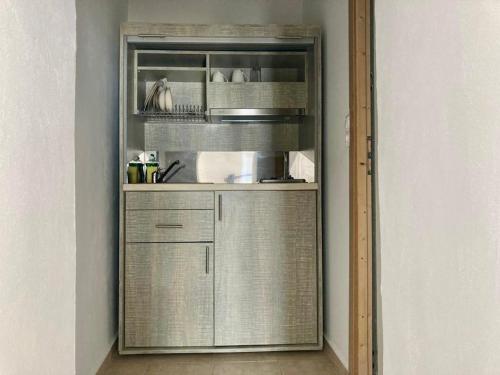 a kitchen with a stainless steel refrigerator in a room at PALS Studios Lindos in Líndos