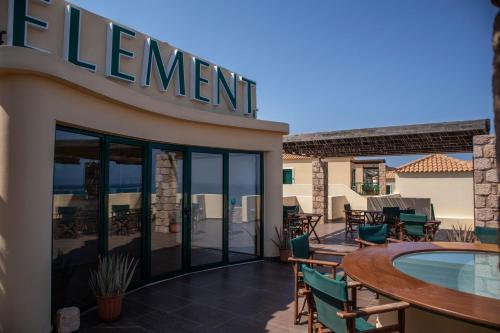 a hotel with a swimming pool and a sign that reads retirement at Element Hotel in Elafonisos
